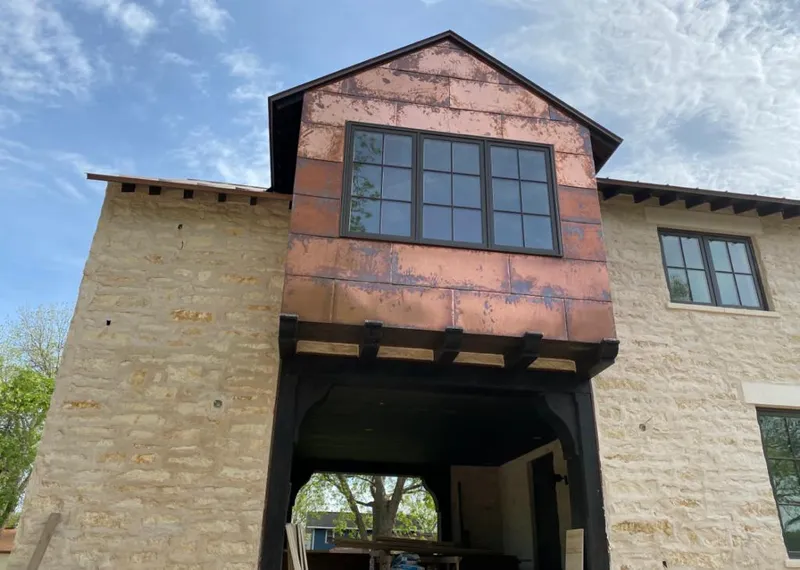 Copper metal panel facade on a stone building for Metal Roof Coating in Elm Grove